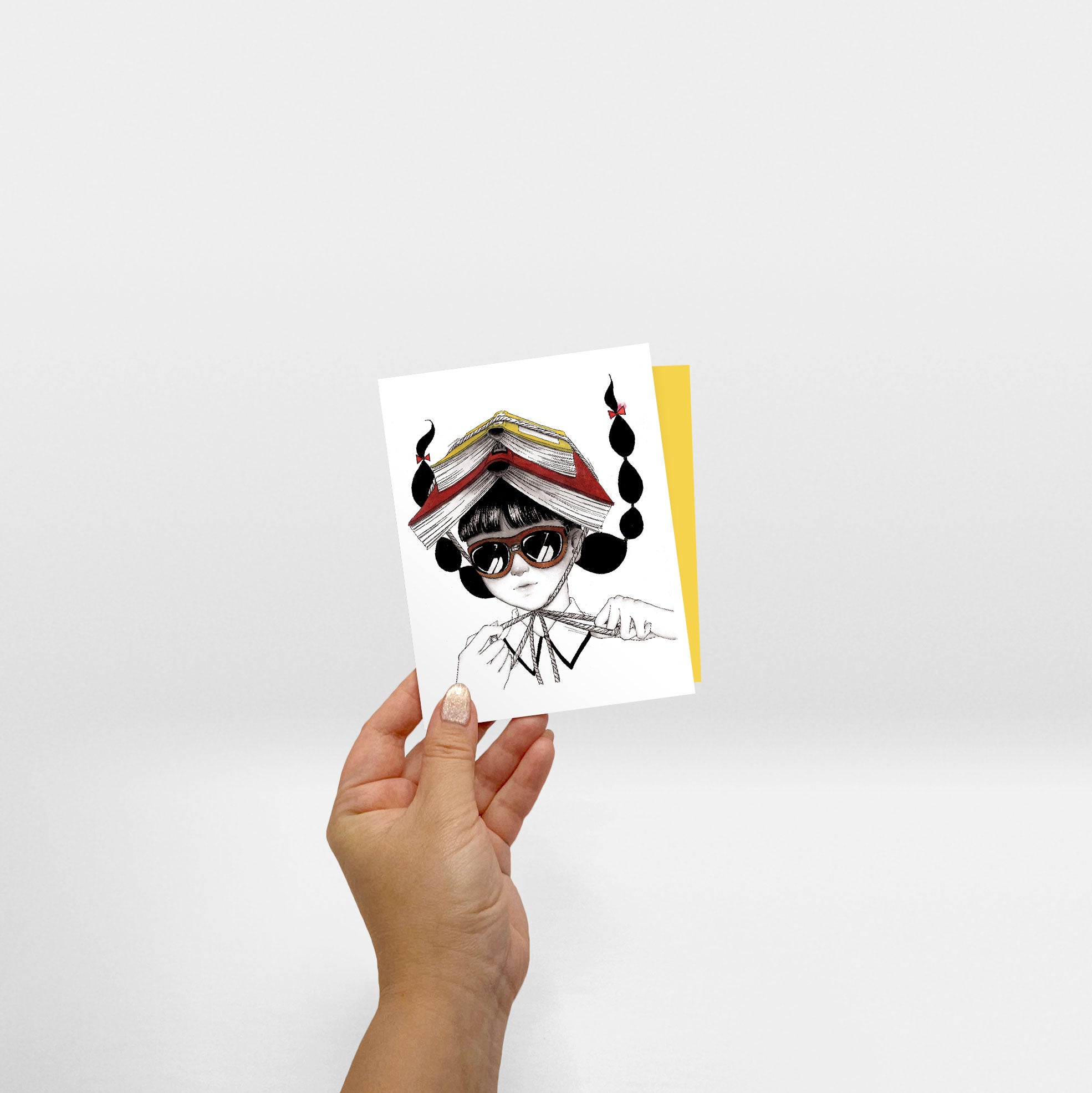 Hand holding Book Helmet card - Sabrina Tanaka Art
